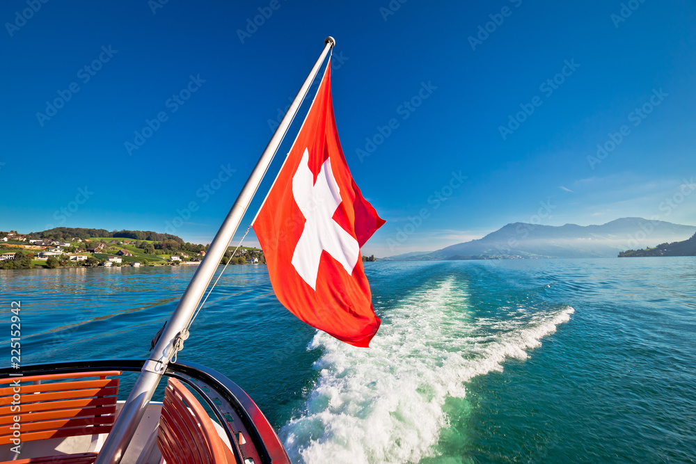 Fototapeta premium Switzerland flag on boat flowing Luzern lake