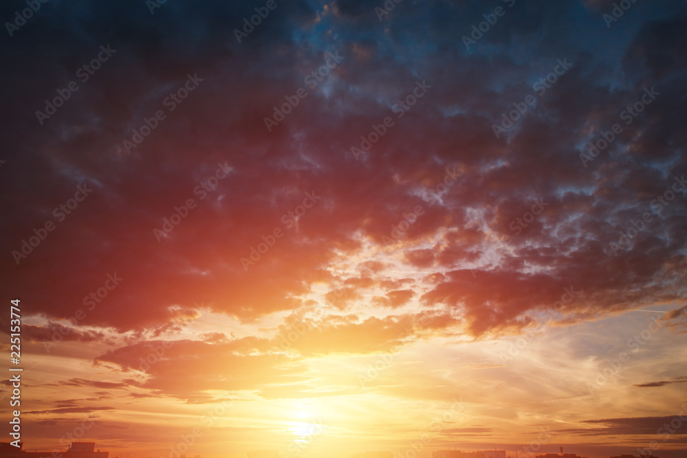 Creative background. Beautiful, atmospheric sunset in the sky. Red, yellow rays of the setting sun. copy space