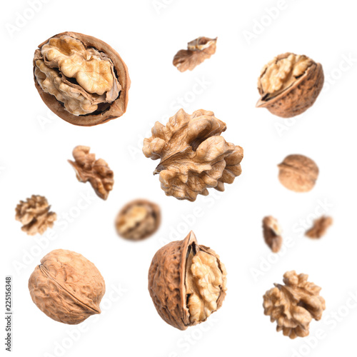 Falling walnuts isolated on white background