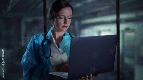 Doctor looking at the monitor of the laptop, typing on the computer, working in the hospital, medicine