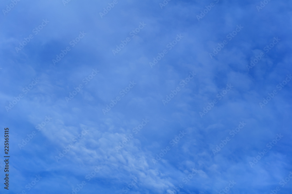 celestial background - blue day sky with white cirro-cumulus clouds