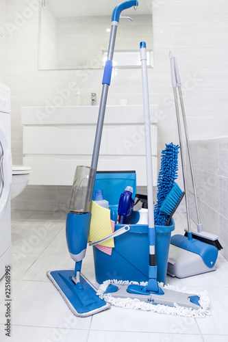 Cleaning service. Bucket with sponges, chemicals bottles and mopping stick. Household equipment