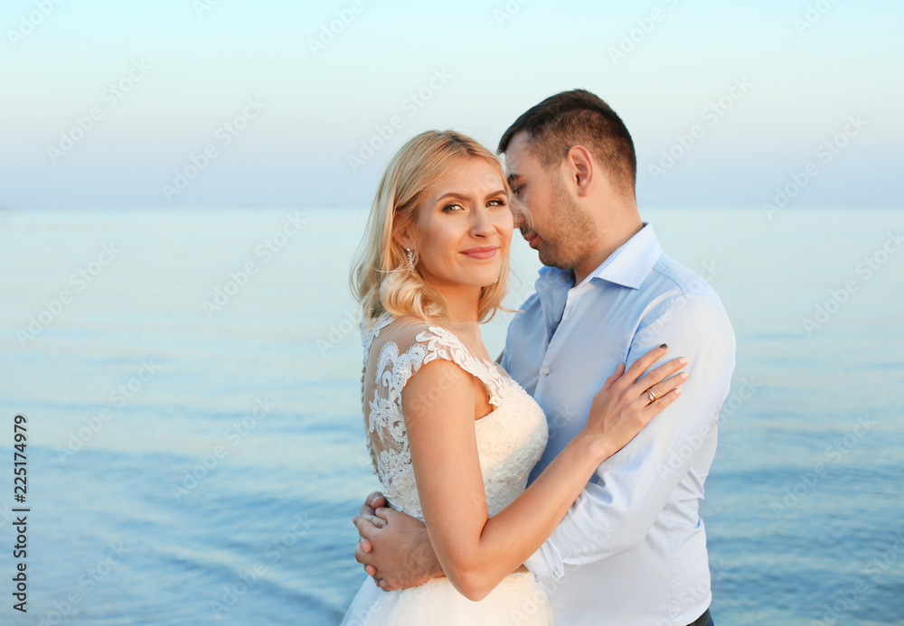Wedding couple. Groom hugging bride on beach Wedding couple. Groom hugging bride on beach