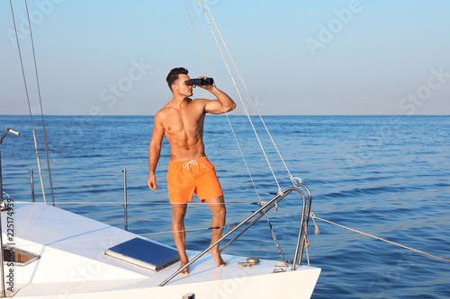 Young man relaxing on yacht during sea trip