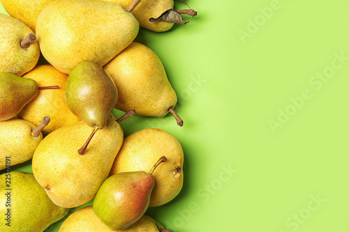 Flat lay composition with fresh ripe pears and space for text on color background