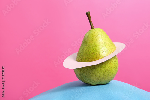 Creative composition with fresh ripe pear and space for text against color background