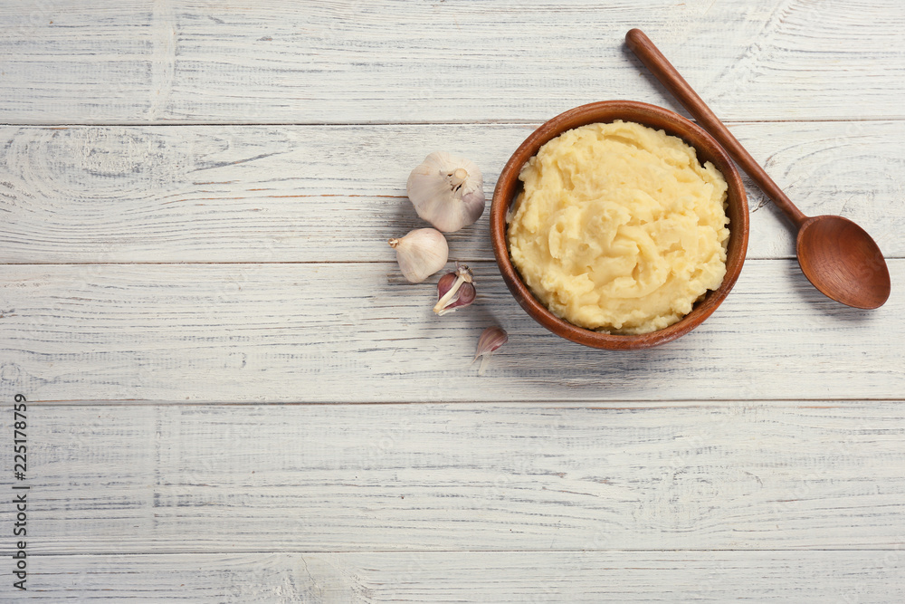 Flat lay composition with mashed potatoes on wooden background. Space for text