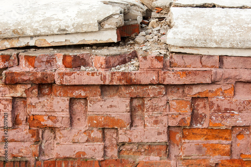 Broken wall of red brick.