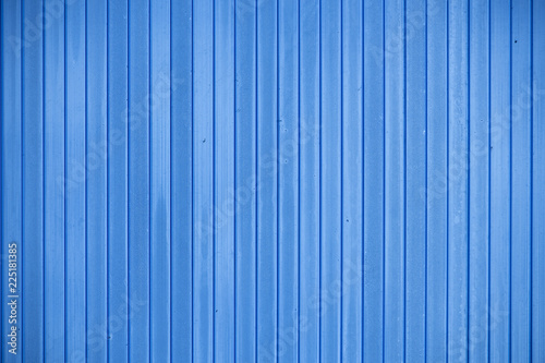Blue fence made of smooth vertical boards