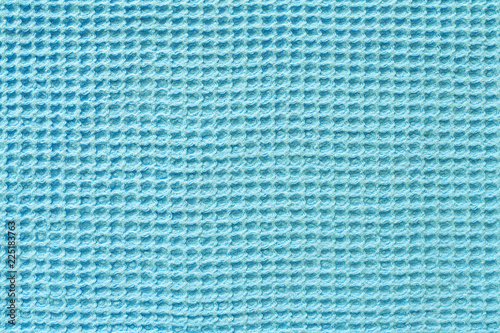Close up view of a turquoise waffle fabric as background, texture (abstract)