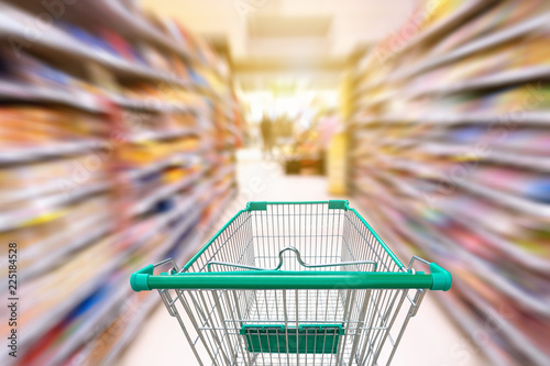 Motion Blur in Supermarket Interior Storage Shelf and Shopping Cart, Consumer Products Goods on Shelves With Trolley Inside Shopping Mall. Abstract Defocused Blurred in Department Store.