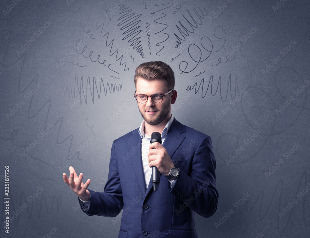 Businessman speaking into microphone with scribbles over his head Businessman speaking into microphone with scribbles over his head
