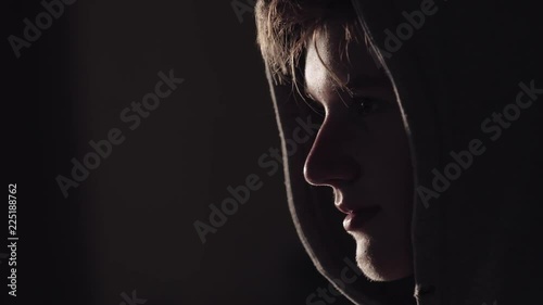 Young man seating in front of big screen in the dark room with warm light . Web tehcnology and internet concept.