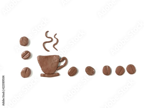 A cup of hot coffee placed in the lower left corner with coffee beans arrange line are handmade from brown plasticine clay on white background, delicious caffeine drink dough