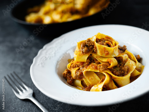 rustic italian pappardelle bolognese pasta in meat sauce photo