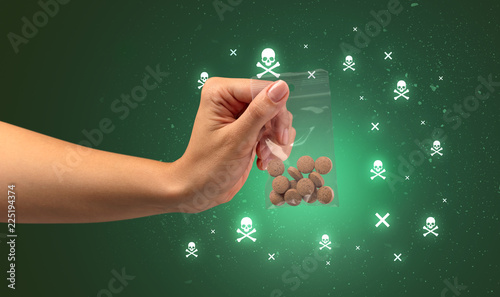 Female handing over pills with skull concept  photo