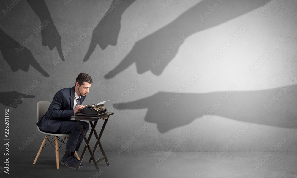 Shadow hand pointing at a small afraid worker
Shadow hand pointing at a small afraid worker