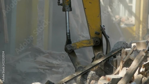 Demolition house using excavator in city. Rebuilding process.