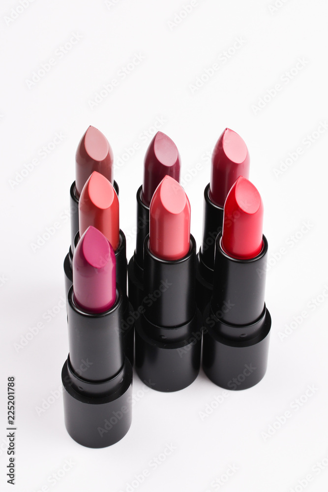 Many different lipsticks, different colors on lilac background. Space for text or design. Many different lipsticks, different colors on lilac background. Space for text or design.