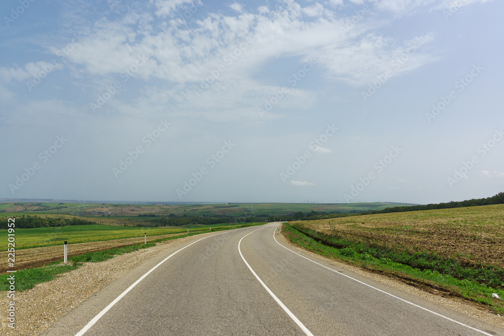 Empty road among agricultural fields in the Anapa district of the Krasnodar region