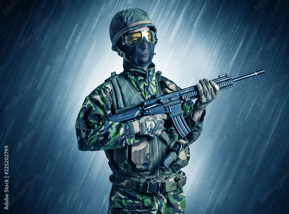 Armed soldier standing in rainy weather
