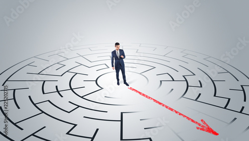 Businessman going through the maze with red arrow 