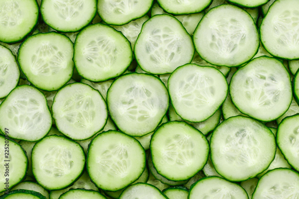 Fresh green slices of cucumber as background Fresh green slices of cucumber as background