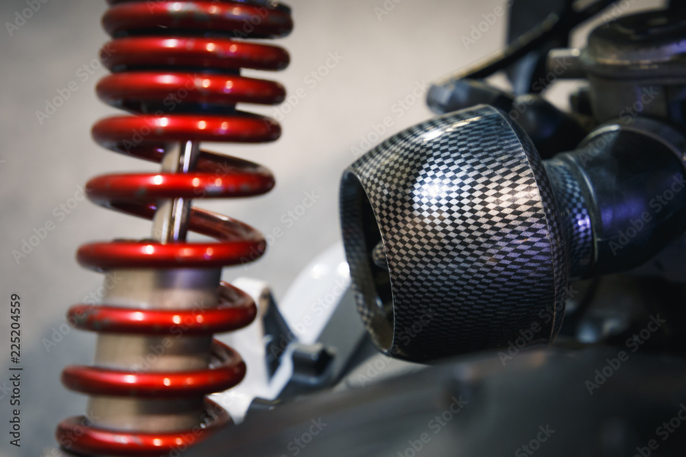 Close up view on rear shock absorber for a motorcycle. Rear view. Close Up of Motorcycle Shock Absorber and Spring Close up view on rear shock absorber for a motorcycle. Rear view. Close Up of Motorcycle Shock Absorber and Spring