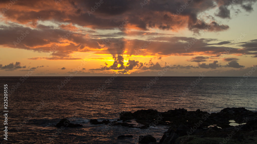 Amazing sunset in the ocean with some small clouds Amazing sunset in the ocean with some small clouds