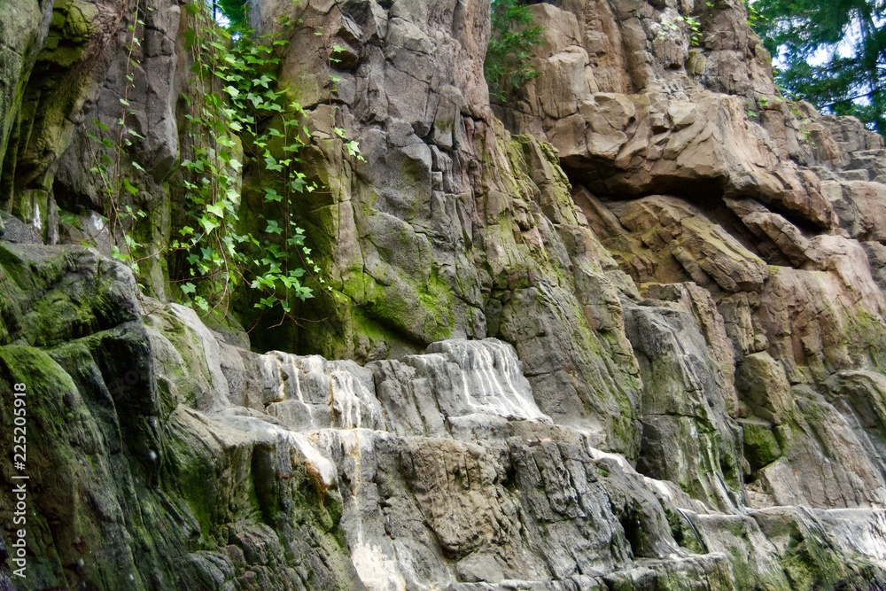 A small pond with plants, branches and rocky mountains and cliffs in the natural park in Portugal A small pond with plants, branches and rocky mountains and cliffs in the natural park in Portugal