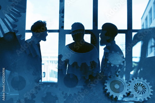 Business team with gears system. Teamwork, partnership and integration concept. double exposure