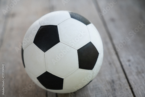 Soccer ball on old wooden floor, Copy space