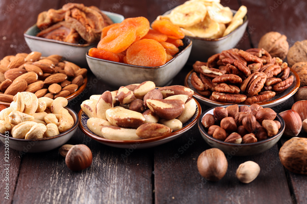 dried fruits and assorted nuts composition on rustic table