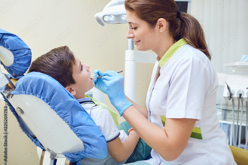 A child with a dentist in a dental office. Dental treatment in a children's clinic. A child with a dentist in a dental office. Dental treatment in a children's clinic.