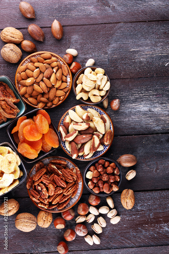 Fototapeta Naklejka Na Ścianę i Meble -  dried fruits and assorted nuts composition on rustic table