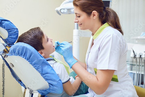 A child with a dentist in a dental office. Dental treatment in a children s clinic.