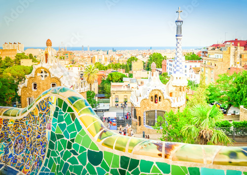 Gaudi mosaic bench and cityscape of Barcelona from park Guell, famous view of Barcelona, Spain, toned