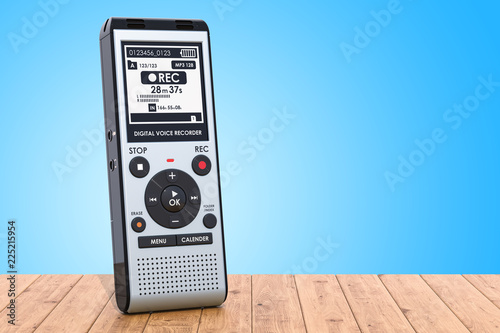 Modern digital voice recorder, dictaphone on the wooden table. 3D rendering photo