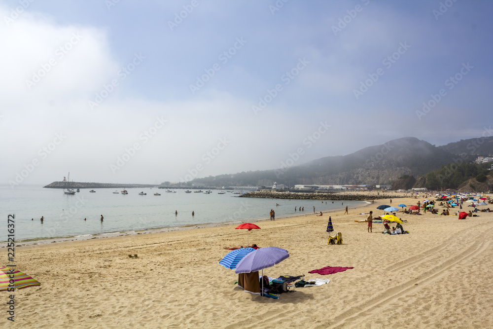 People on the beach on hot foggy day People on the beach on hot foggy day