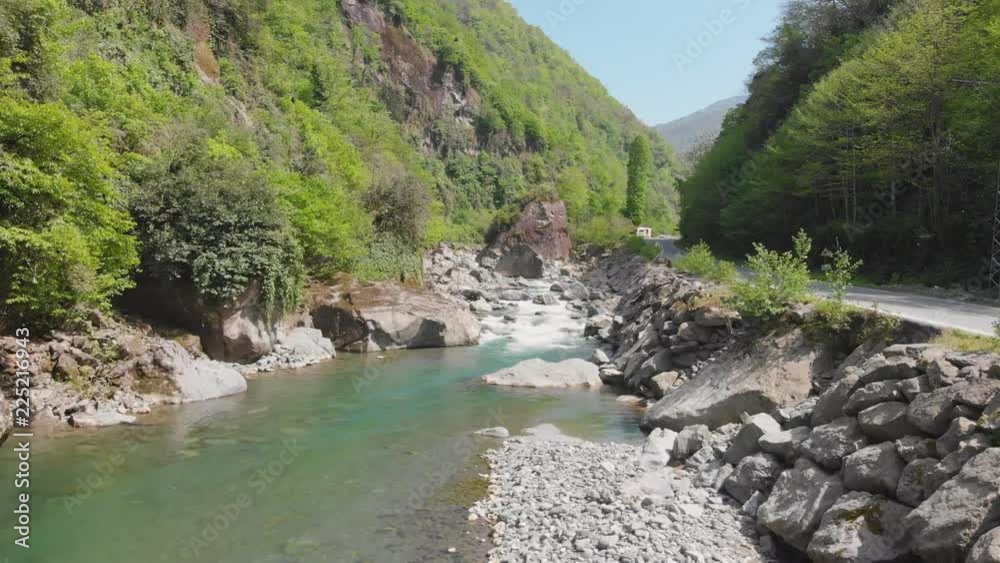 wild river flowing at a rough green terrain