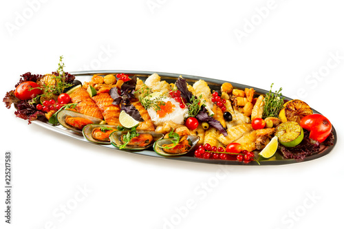 Top view metal dish set of seafood, fish and vegetables isolated at white background.