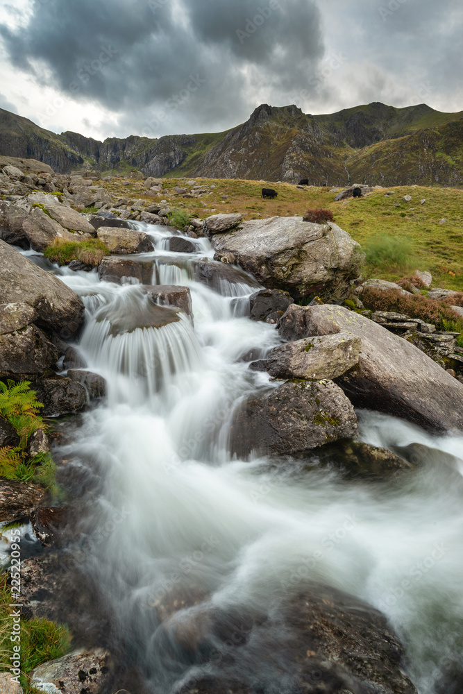 Moody landscape image of river flowing down mountain range near Llyn Ogwen and Llyn Idwal in Snowdonia in Autumn Moody landscape image of river flowing down mountain range near Llyn Ogwen and Llyn Idwal in Snowdonia in Autumn