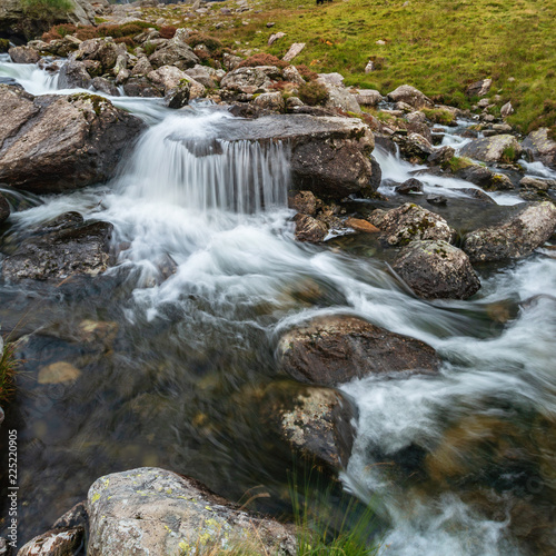 Moody landscape image of river flowing down mountain range near Llyn Ogwen and Llyn Idwal in Snowdonia in Autumn