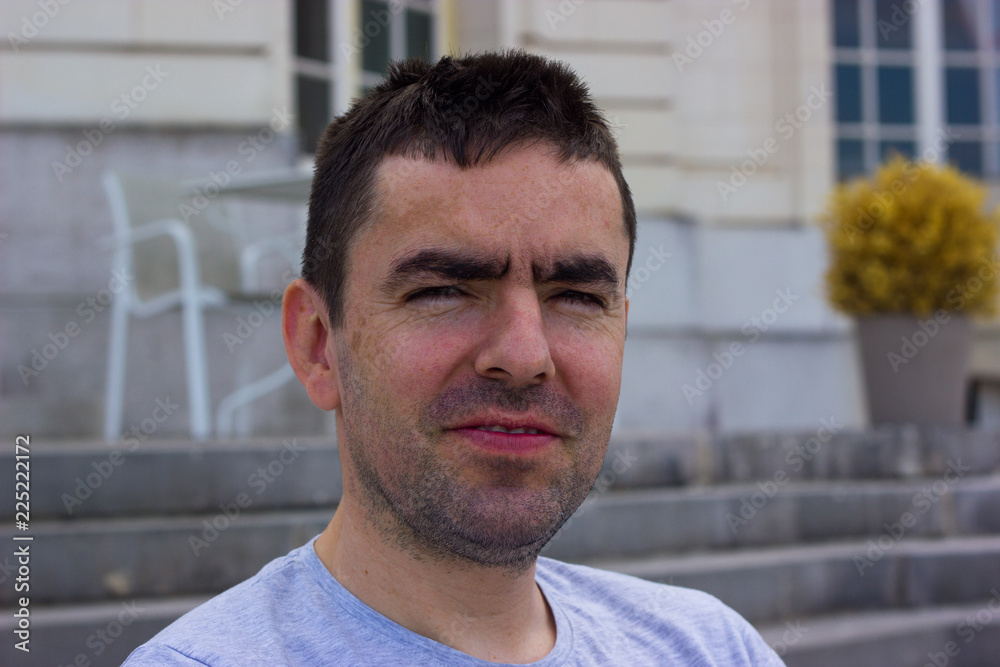 Unshaven middle-aged man with a displeased expression Unshaven middle-aged man with a displeased expression