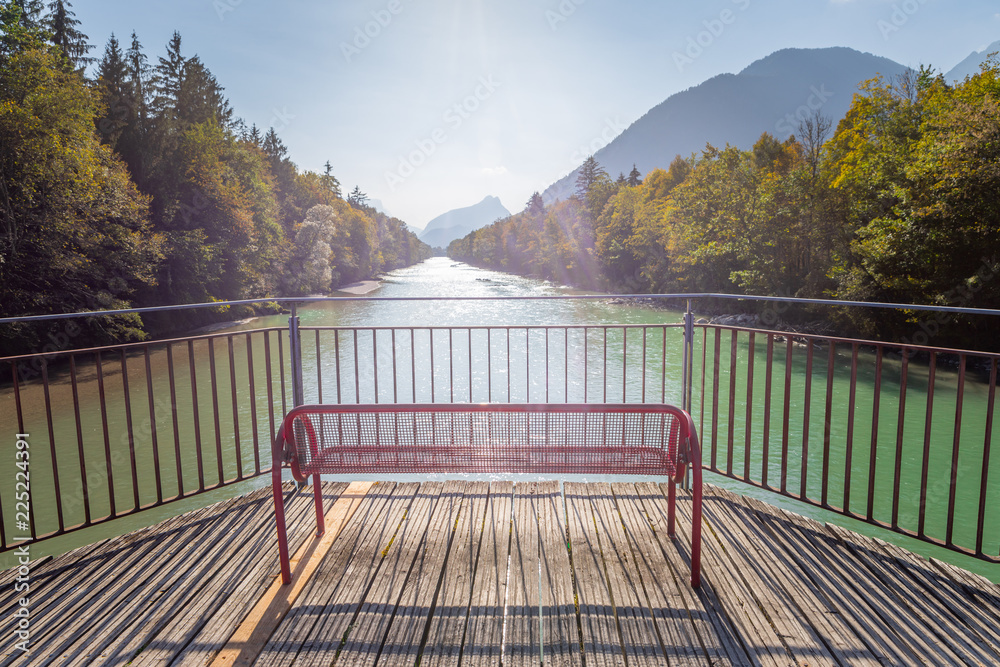 Farbenfrohe Spazierbank mit Aussicht auf Fluss und Wälder, Herbsttag, blauer Himmel Farbenfrohe Spazierbank mit Aussicht auf Fluss und Wälder, Herbsttag, blauer Himmel