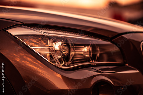 Headlights and hood of sport brown car © Makulov