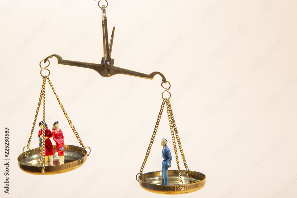 Depicted in a conceptual image by  a seesaw showing the male and female genetic symbols in equilibrium. Equality between the sexes.   Feminism and equality