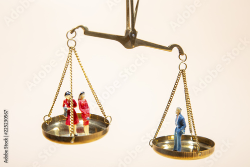 Depicted in a conceptual image by a seesaw showing the male and female genetic symbols in equilibrium. Equality between the sexes. Feminism and equality