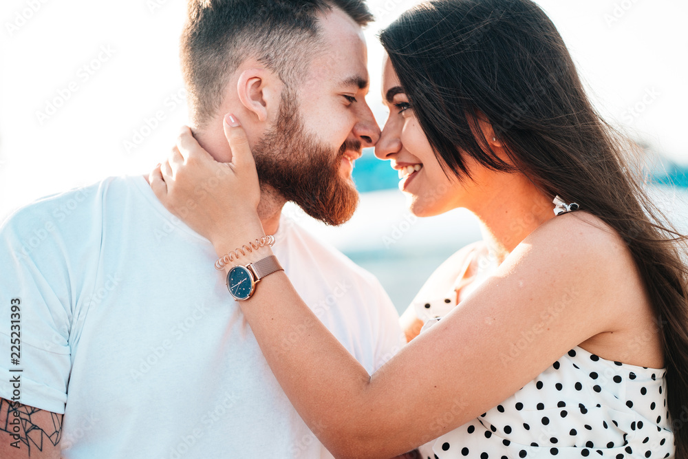 Handsome guy and beautiful girls kissing on the background of a fountain Handsome guy and beautiful girls kissing on the background of a fountain