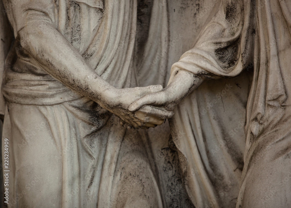 Sculpture of Hands saying Good-bye on a Marble Tombstone 